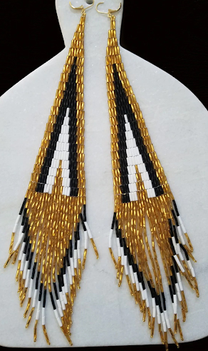 Stiletto earrings, 2022,
Black, gold and white
twisted bugle beads,
woven together. Finished
with gold filled leverback
hooks, 10.5 in., Courtesy of
the artist