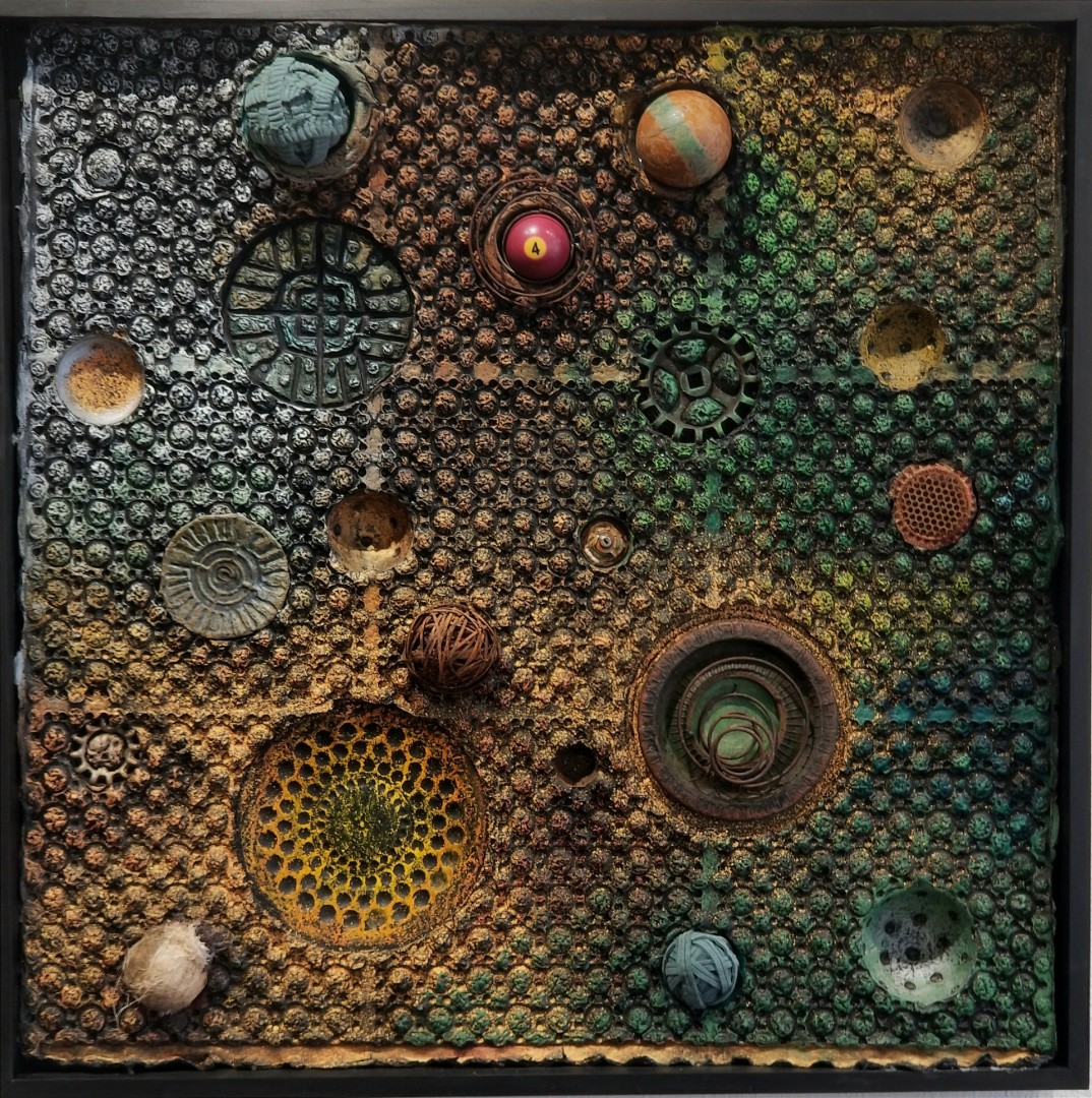 Artist Dawn Wohlford Paint, oil pastels, and found objects on handmade, cast paper titled chaos in the cosmos.